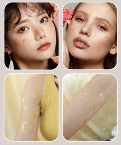 Macro detail of gold metallic freckle tattoos with stars and moon for face and body