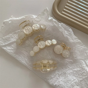 Set of four white acrylic pearl hair claw clips with elegant mother of pearl texture