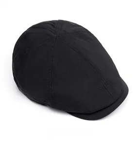 Top view of a black quick-dry newsboy cap showing multi-panel stitching and nylon fabric