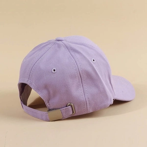 Detail view of the lavender baseball cap with adjustable metal buckle and cotton fabric