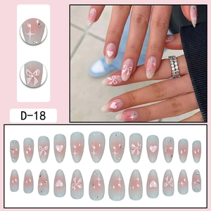 Pink and blue gradient almond press-on nails with 3D bows and heart rhinestone accents