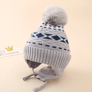 Detail of grey winter knit hat for boys featuring jacquard diamond pattern and pompom