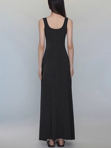 Back view of a long black sleeveless dress with deep U-neckline and slim fit design