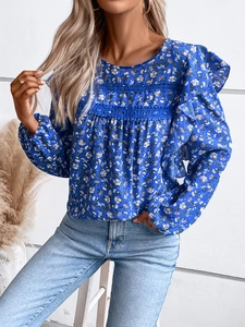 Close-up detail of blue floral long sleeve blouse with lace trim and ruffle design