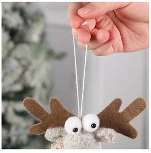 Close-up of a handmade beige felt reindeer ornament with brown antlers and hanging string