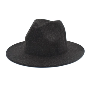 Detailed macro view of dark grey wool felt texture on a classic fedora hat brim