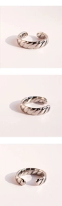 Detailed views of the silver wave twist texture on an adjustable open ring design