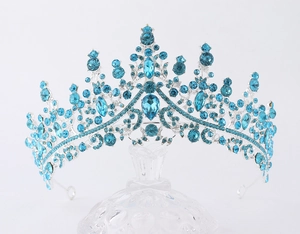 Detailed close-up of a silver bridal crown featuring large blue sapphires and crystals