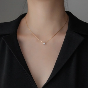 Elegant gold six-prong round diamond pendant necklace on a minimalist fine chain