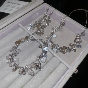 Detailed view of silver water drop tassel jewelry set in a luxury velvet display box