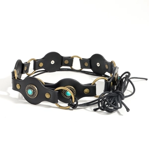 Detail of vintage black leather belt featuring turquoise studs and gold metal rings