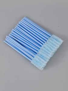 Detail view of disposable light blue mascara wands with dense spiral bristles and metal core