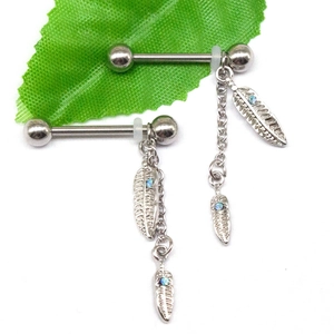Detailed view of silver nipple rings featuring feather pendants and blue opal stones