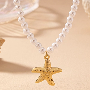 Elegant pearl necklace with a golden starfish pendant against a minimalist beige background