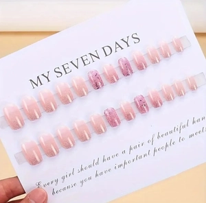 Detailed view of pink gradient short square press-on nails with silver glitter and sequins