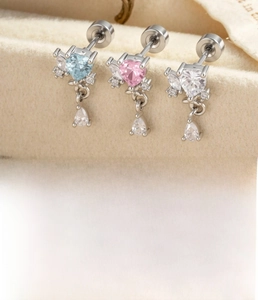 Macro detail of heart zircon earrings with water drop pendants in silver titanium steel