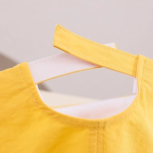 Detail of adjustable hook-and-loop strap on a yellow quick-dry toddler sun hat