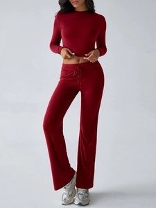 Detail of dark red ribbed two-piece set featuring long sleeve crop top and drawstring pants