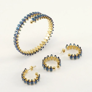 18K gold plated stainless steel jewelry set with marquise blue stones on white background