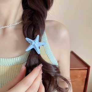 Light blue starfish hair clip with realistic texture worn on a brown braided hairstyle