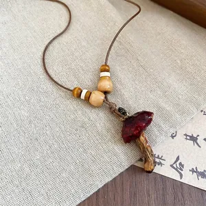 Vintage red mushroom resin pendant necklace with wooden beads on a brown cord