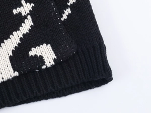 Macro shot of black and white jacquard knit fabric with premium ribbed texture and pattern