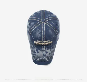 Detailed top view of a washed denim baseball cap with yellow embroidery and print