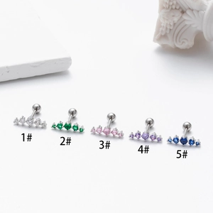 Detail view of colorful zircon ear studs in silver stainless steel finish
