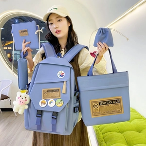 Five-piece blue nylon school backpack set for students including tote and plush charm