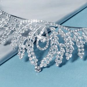 Detail of silver alloy bridal tiara featuring rhinestone leaves and vine patterns