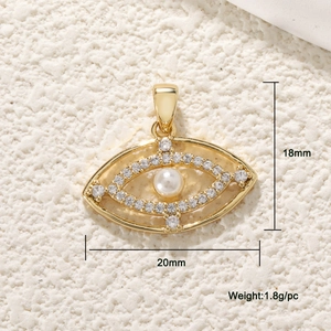 Macro shot of gold evil eye charm with pearl center and cubic zirconia stones, 18mm by 20mm