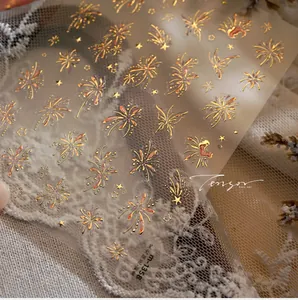 Macro shot of M-1358 gold foil nail stickers with firework and butterfly patterns