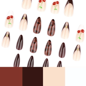 Short almond press-on nails featuring 3D cherry designs, amber textures, and brown french tips