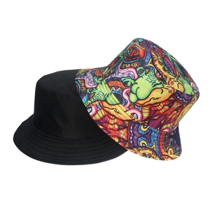 Detail view of cotton sun bucket hats in solid black and colorful graffiti pattern
