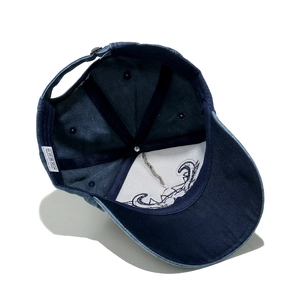 Detail view of cotton baseball cap interior featuring reinforced seams and 100% cotton label