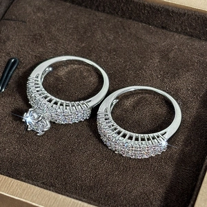 Close-up of sparkling zircon engagement ring set in a brown velvet jewelry gift box