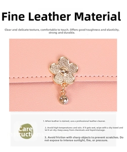 Detailed view of pink leather texture and golden floral metal charm on the crossbody bag