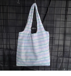 Gros plan du sac fourre-tout à rayures bleues et violettes montrant la texture du tissu