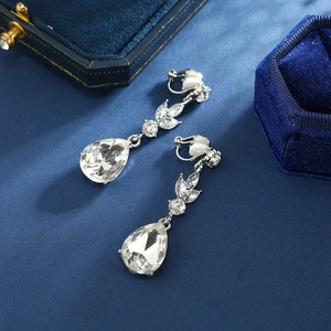 Elegant teardrop crystal clip-on earrings with silver metal base on a blue velvet box