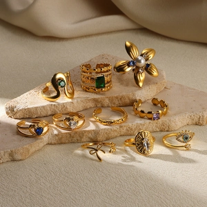 Gold stainless steel rings set featuring flower, heart, and eye motifs with zircons