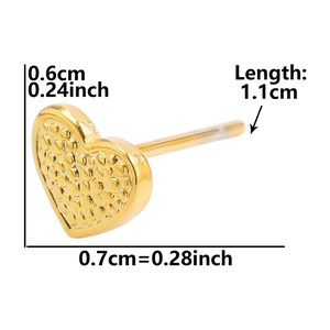 Macro shot showing dimensions and grainy texture of gold heart stainless steel stud earring