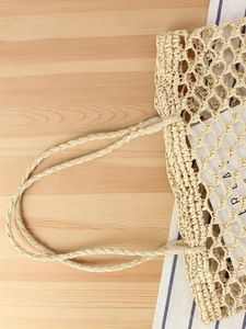 Handmade woven hollow straw handbag in beige for casual beach vacation styling
