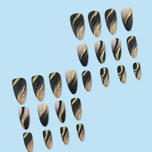 French tip stiletto press-on nails with black gradient and gold glitter wave patterns