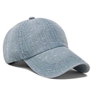 Detail of light blue distressed denim baseball cap with white textured jacquard patterns