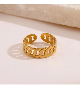 Close-up of golden chain link ring with adjustable open band on stone background