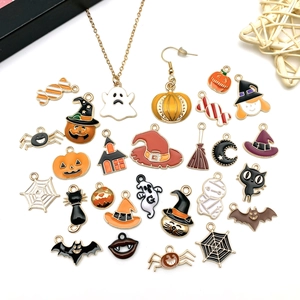 Flat lay of colorful Halloween alloy enamel charms including pumpkins, ghosts and bats