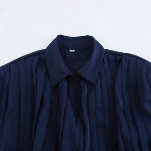 Elegant navy blue satin pleated dress with long sleeves and a sophisticated lapel design