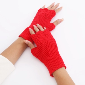 Detail view of red thick knitted fingerless gloves with scale pattern texture