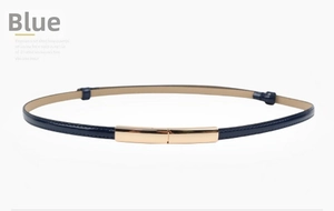 Detail view of a slim dark blue patent leather belt with a rectangular gold metal buckle