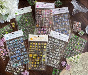 Flat lay of 3D acrylic nature plant stickers with floral motifs on vintage manuscript